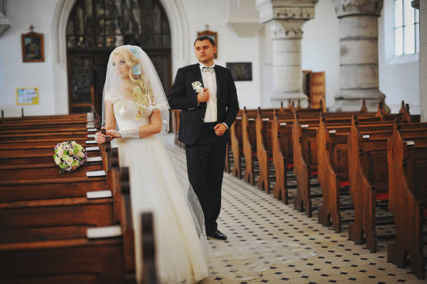 istock Wedding couple at catholic church 664532952