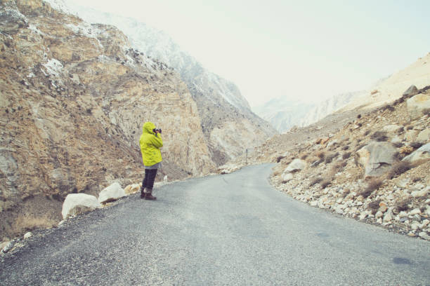 Photographer capturing beautiful views from Himalayan mountain road, Himachal Pradesh, India