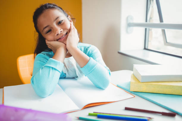 istock Girl sitting at a desk 664534976
