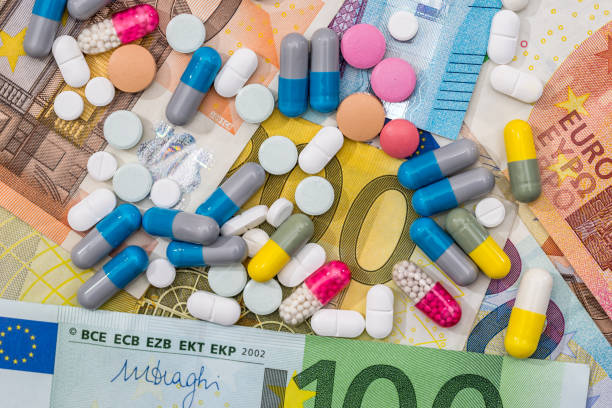 istock different pills above euros bills. close up. 664537596