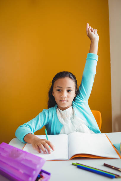 istock A serious girl rising her hand 664537830