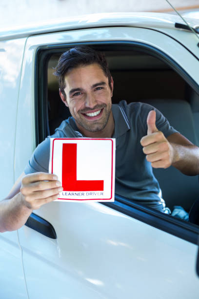 istock Handsome man showing thumbs up while holding L plate 664538008