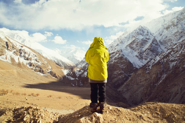 istock Woman in front of snowcapped Himalayan mountain 664539330