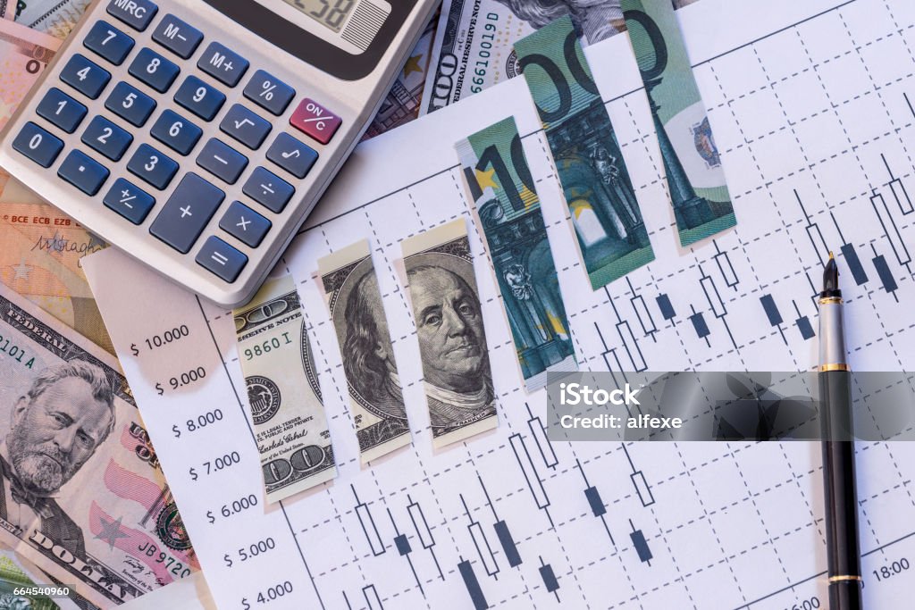 torn dollar and euros bills on forex graph. Bandage Stock Photo