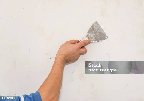Painting Worker Repair Wall Using A Paint Spatula Hand Stock Photo -  Download Image Now - iStock