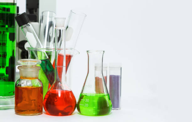 istock science laboratory glassware,Group of laboratory flasks empty or filled with a clear liquid on white tint scientific graphics background and their reflection on a table,science background,science glassware and selective focus. 664564688