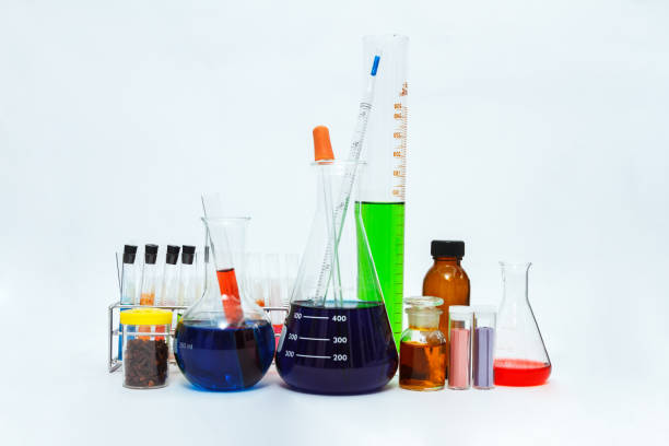 istock science laboratory glassware,Group of laboratory flasks empty or filled with a clear liquid on blue tint scientific graphics background and their reflection on a table,science background,science glassware and selective focus. 664564740