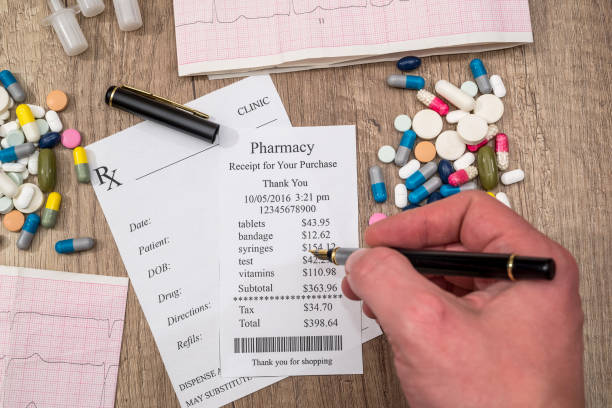 istock man showing on  pharmacy receipt with rx blank, pills, syringe on desk. 664565190