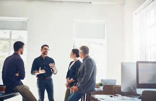 Shot of a group of designers having a discussion at work