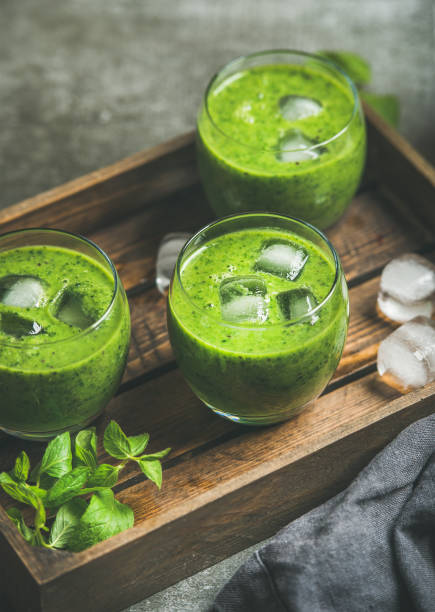 istock Fresh smoothie with ice cubes, mint and lime in glasses 664569064