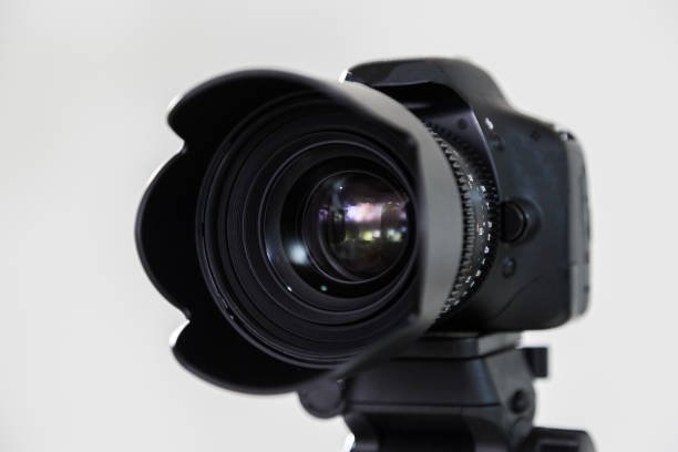 istock Digital SLR camera with interchangeable manual lens on a gray background. Shooting in the interior. The equipment for filmmaking 664572540