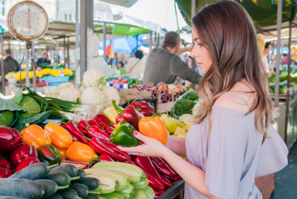 istock woman selecting pepper while in a supermarket 664573076