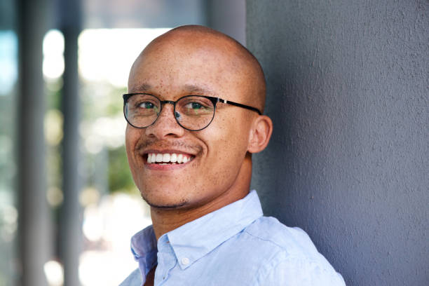 istock Smiling african businessman with glasses 664576596