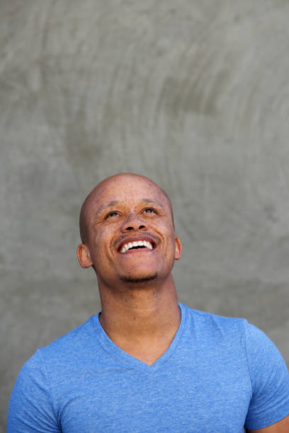 istock happy black man laughing and looking up 664576654
