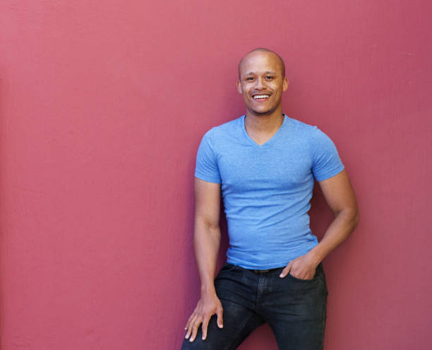 istock handsome cool african man smiling against red background 664576672
