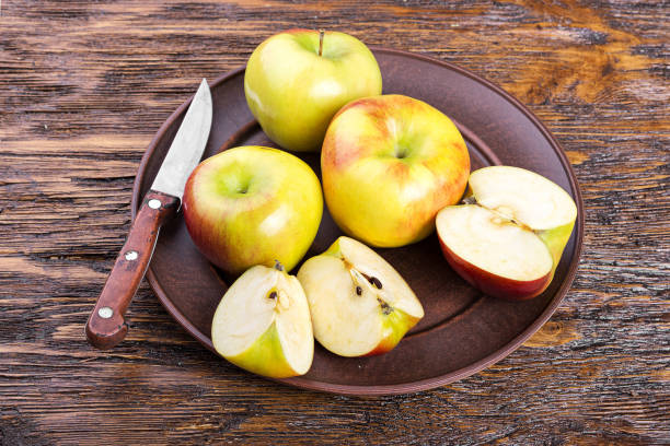 istock sliced apple on a wooden board 664576716