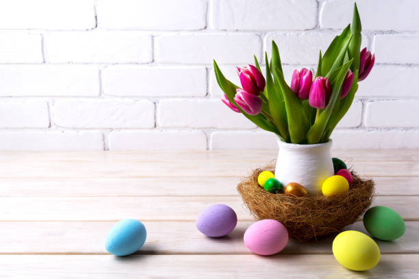 istock Easter table centerpiece with decorated eggs in nest 664579200