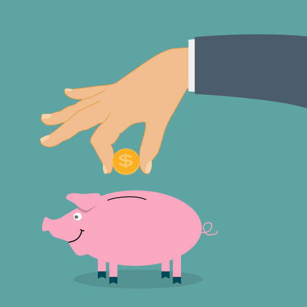 istock Smiling, pretty pink pig piggy bank with falling coins - Contrib 664579520