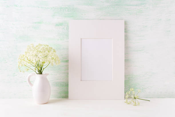 istock Easy white frame mockup with tender wild flowers in pitcher 664580998