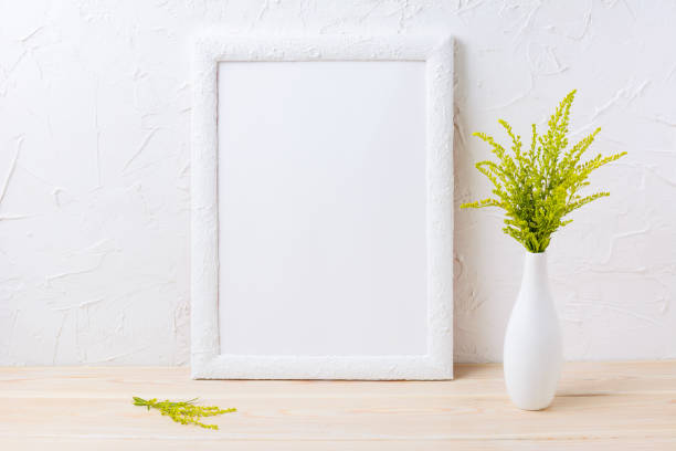 istock White frame mockup with ornamental grass in exquisite vase 664581038