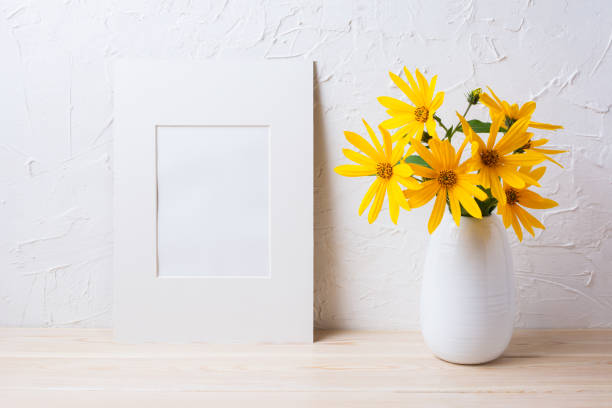 istock White mat frame mockup with yellow rosinweed flowers in pitcher 664581090