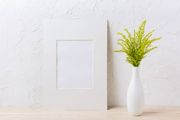 istock White mat frame mockup with ornamental grass in exquisite vase 664581102