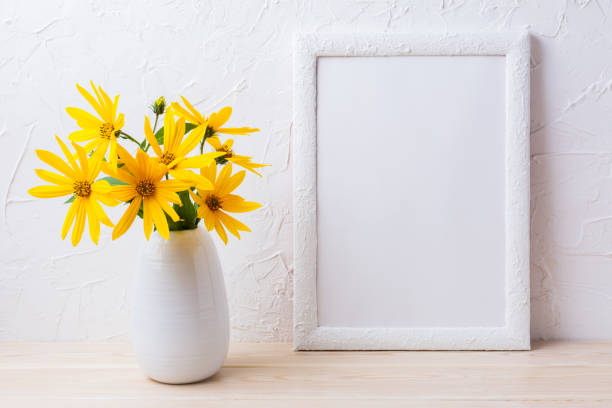 istock White frame mockup with yellow rosinweed flowers in pitcher 664581140