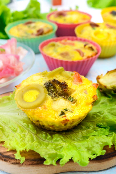 Omelette with colored pasta, mushrooms, vegetables and herbs, cooked in the form of mafins.  Breakfast.