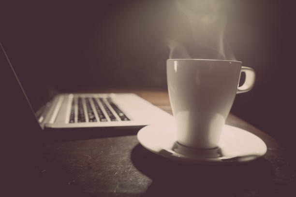 istock Laptop keyboard, with a cup of hot coffee 664582402