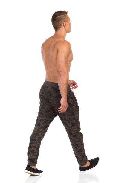 istock Walking Half Naked Man In Camo Pants Rear Side View 664587610