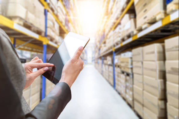 istock Female manager working at modern warehouse 664588514