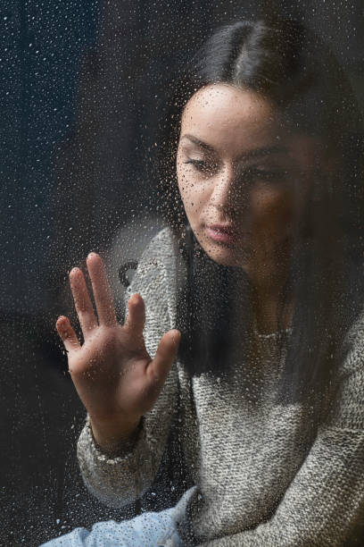 istock Sitting by her window on a rainy day 664591272