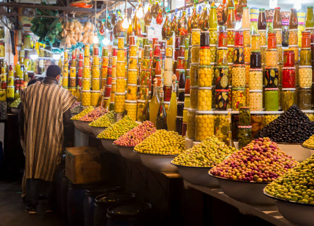 Olives shop in Jemaa El-Fnaa Pictures of a couple of olives shops in Marrakesh at the Jemaa El-Fnaa square. Taken in Morocco in 2017 djemma el fna square stock pictures, royalty-free photos & images