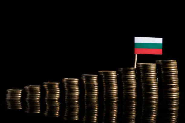 Bulgarian flag with lot of coins isolated on black background