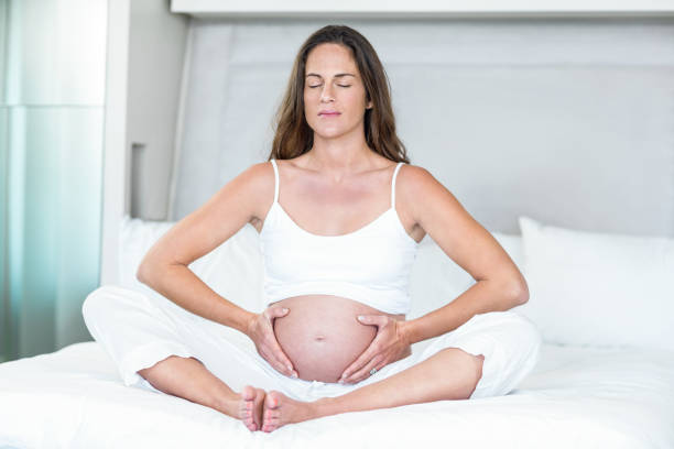 istock Woman exercising yoga on bed 664594956