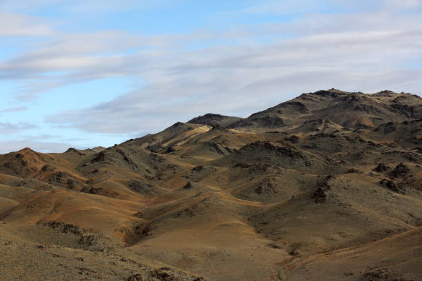 istock Highland steppe with mountains cloudy dramatic blue sky in beautiful sunrise 664595102