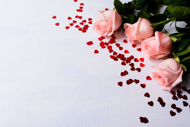 istock Wedding background with pale pink rose and red hearts 664595610