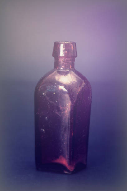 istock Old colourful bottles against a dark background 664595864