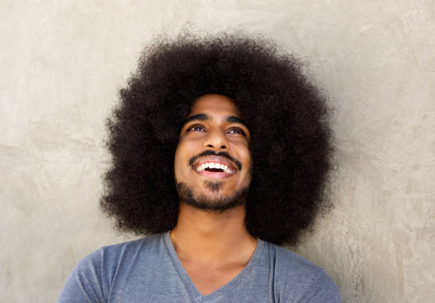 istock happy man with beard and afro looking up 664603590