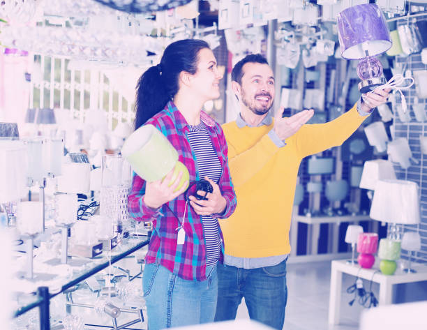 istock Couple is considering models of night lights 664603832
