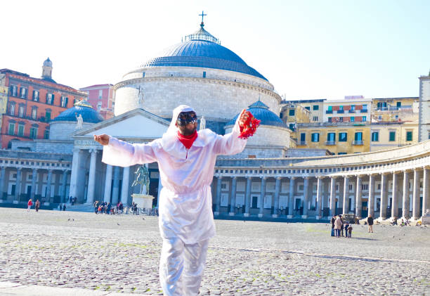 Napoli, Italy - December 23th, 2016: A man dressed as Pulcinella dances in Piazza del Plebiscito