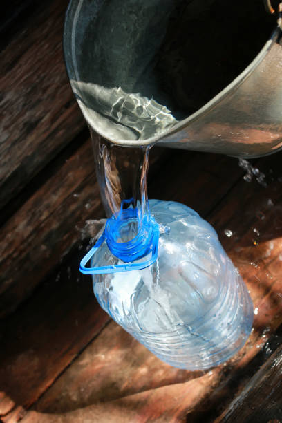 istock draw water from the well 664606392