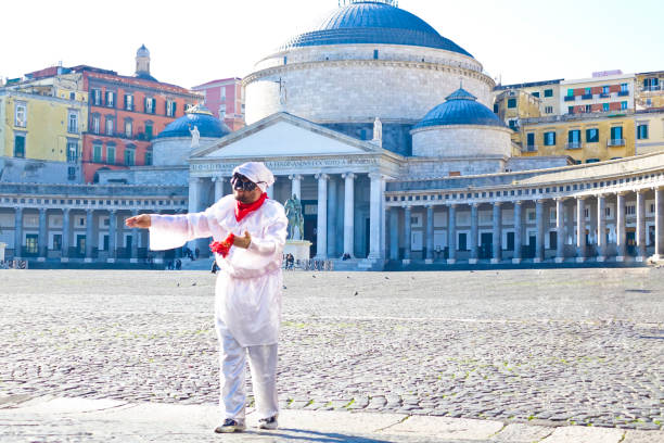 Pulcinella in Piazza del Plebiscito, Naples Napoli, Italy - December 23th, 2016: A man dressed as Pulcinella dances in Piazza del Plebiscito piazza plebiscito stock pictures, royalty-free photos & images