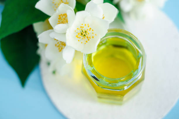 istock Aroma massage oil (perfume) with jasmine essence. Spa concept 664610954