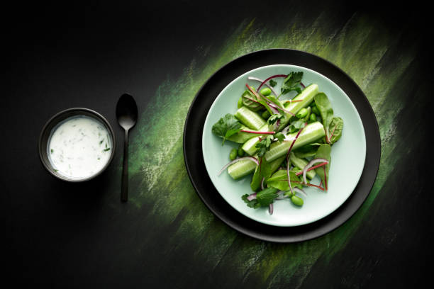 istock Salads: Salad with Cucumber, Lettuce, Soybeans, Parsley and Yoghurt Dressing 664611410