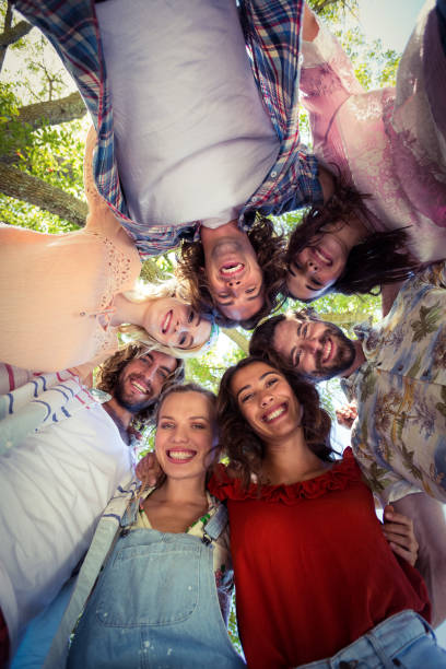 istock Happy friends forming a huddle in park 664615068