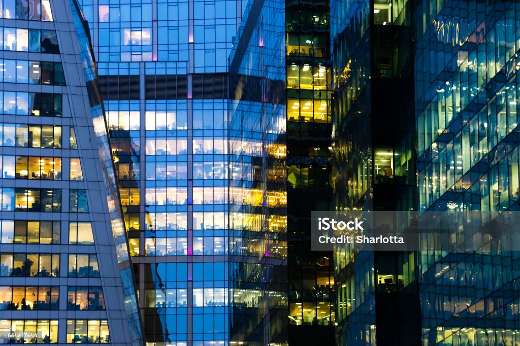 Modern office building at night Modern office building at night. Glowing windows Large Stock Photo