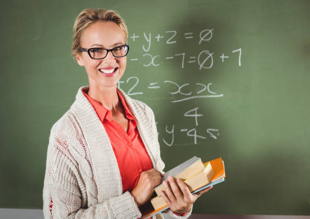 istock Teacher holding books 664617710