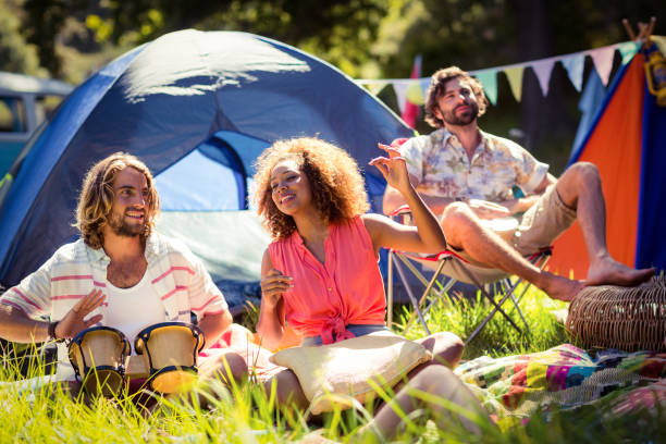 istock Friends having fun together at campsite 664618126