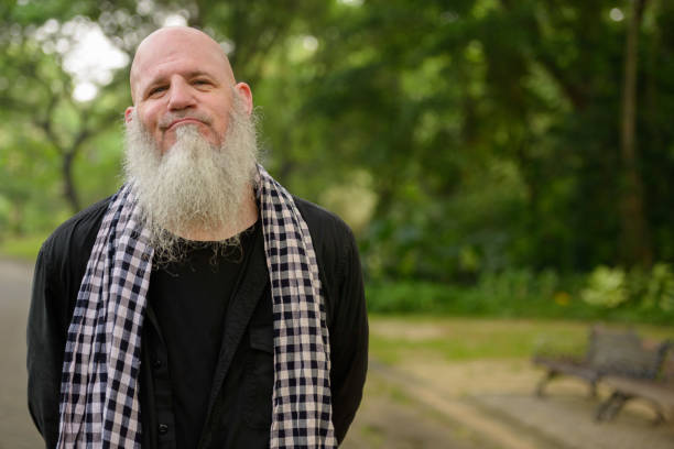 istock Mature bald bearded man in nature park 664618552